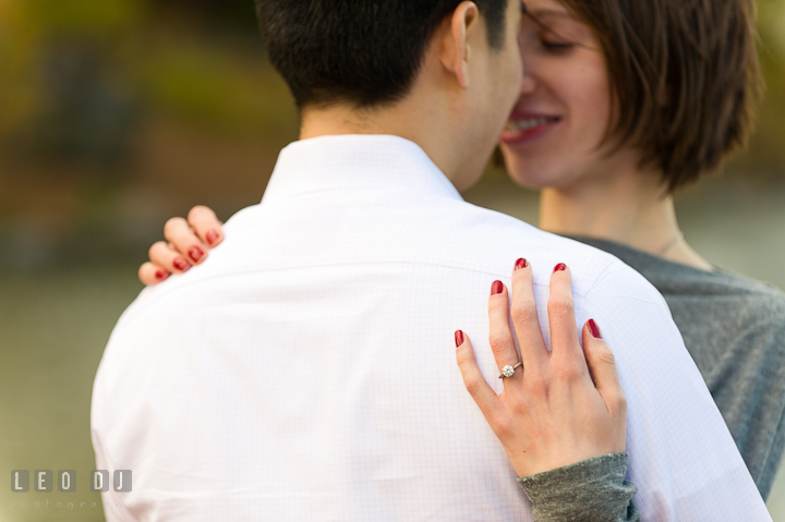 Engaged girl hugging with her fiancé at Central Park showing her diamond engagement ring. Pre-wedding engagement photo session at New York City, NY, by wedding photographers of Leo Dj Photography. http://leodjphoto.com
