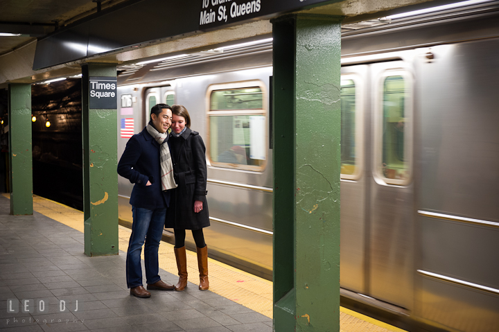 Engaged couple cuddling at Times Square metro station platform. Pre-wedding engagement photo session at New York City, NY, by wedding photographers of Leo Dj Photography. http://leodjphoto.com