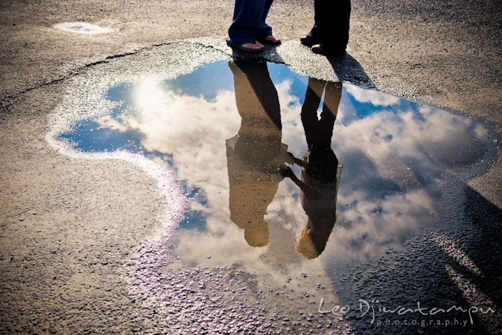 Reflection of engaged couple holding hands on a puddle. Stevensville, Kent Island, Maryland, Pre-Wedding Engagement Photographer, Leo Dj Photography