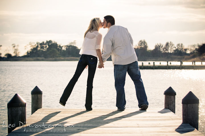 A fiancé and his fiancée kissed at the end of a pier. Stevensville, Kent Island, Maryland, Pre-Wedding Engagement Photographer, Leo Dj Photography