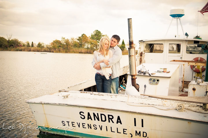 Engaged guy hugged his fiancée on a crabbing boat. Stevensville, Kent Island, Maryland, Pre-Wedding Engagement Photographer, Leo Dj Photography