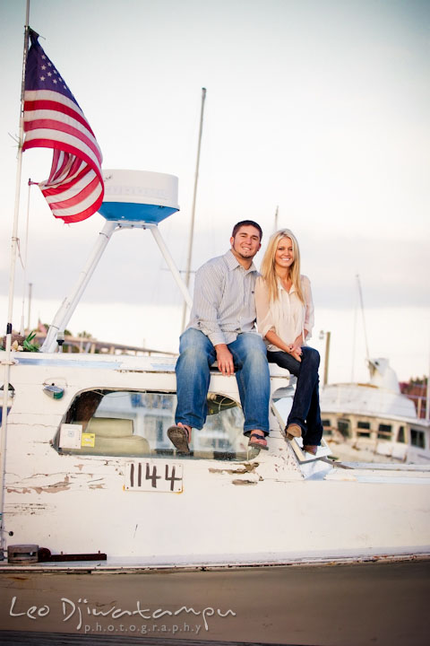 Engaged guy and girl couple sitting on top of a crabbing boat. Stevensville, Kent Island, Maryland, Pre-Wedding Engagement Photographer, Leo Dj Photography