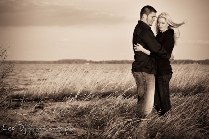 Engaged couple at a beach, hugging. Stevensville, Kent Island, Maryland, Pre-Wedding Engagement Photographer, Leo Dj Photography