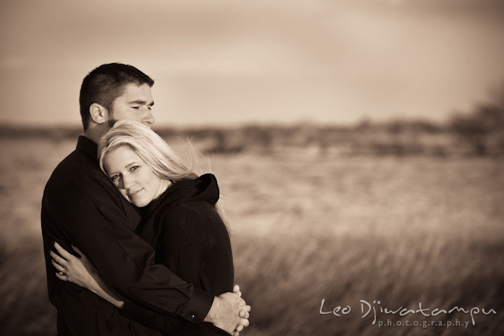 Engaged couple holding each other close on a meadow. Stevensville, Kent Island, Maryland, Pre-Wedding Engagement Photographer, Leo Dj Photography