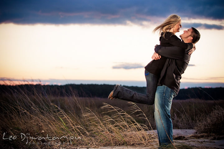 Engaged guy lifted up his fiancée, laughing together. Stevensville, Kent Island, Maryland, Pre-Wedding Engagement Photographer, Leo Dj Photography