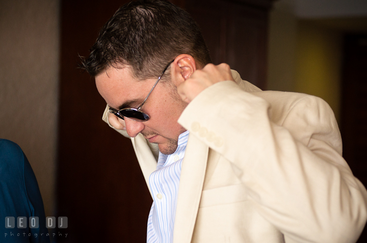 Groom putting on his jacket. Cruise ship destination wedding ceremony photos, Hotel Melia Cozumel Mexico by photographers of Leo Dj Photography.