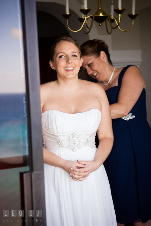 Mother of Bride helping daughter buttoning up her wedding dress. Cruise ship destination wedding ceremony photos, Hotel Melia Cozumel Mexico by photographers of Leo Dj Photography.