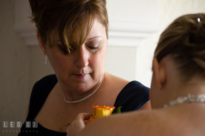 Bride helping mother putting on the boutonniere. Cruise ship destination wedding ceremony photos, Hotel Melia Cozumel Mexico by photographers of Leo Dj Photography.