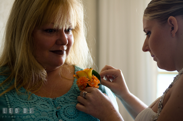 Bride helping step mother putting on the boutonniere. Cruise ship destination wedding ceremony photos, Hotel Melia Cozumel Mexico by photographers of Leo Dj Photography.