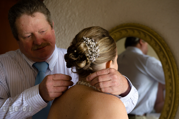 Father of the Bride helping daughter putting on the necklace. Cruise ship destination wedding ceremony photos, Hotel Melia Cozumel Mexico by photographers of Leo Dj Photography.