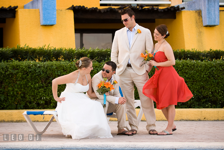 Bride, Groom, and wedding party posing together. Cruise ship destination wedding ceremony photos, Hotel Melia Cozumel Mexico by photographers of Leo Dj Photography.