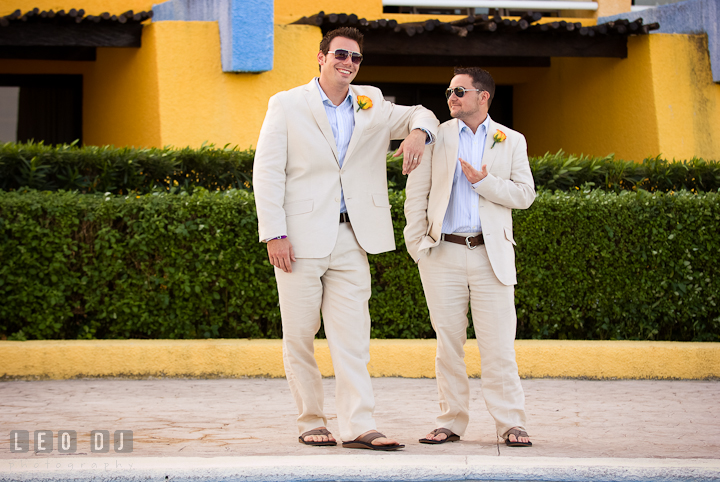 Best Man resting his arm on Groom's shoulder. Cruise ship destination wedding ceremony photos, Hotel Melia Cozumel Mexico by photographers of Leo Dj Photography.