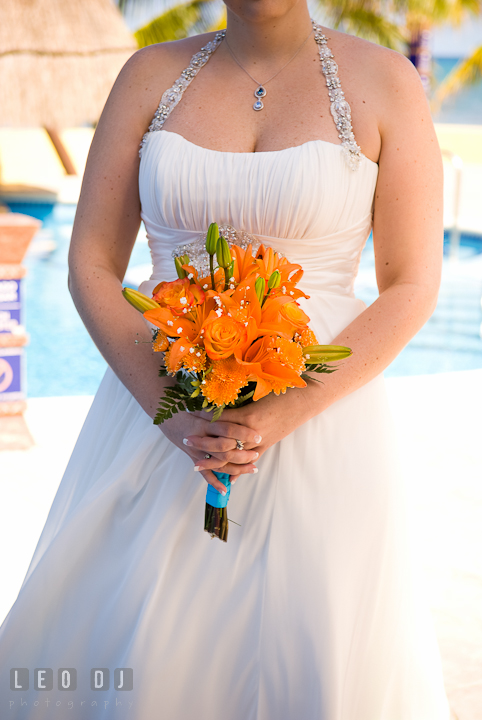 Bride's orang floral bouquet. Cruise ship destination wedding ceremony photos, Hotel Melia Cozumel Mexico by photographers of Leo Dj Photography.