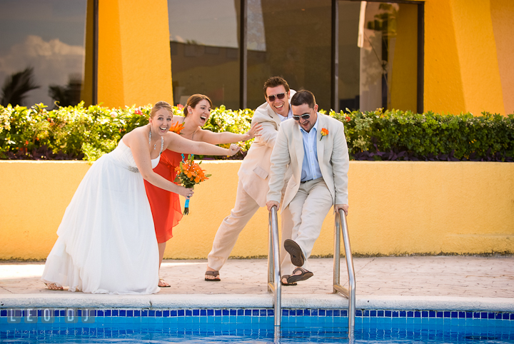 Bride and wedding party trying to stop Groom jumping in to the pool. Cruise ship destination wedding ceremony photos, Hotel Melia Cozumel Mexico by photographers of Leo Dj Photography.