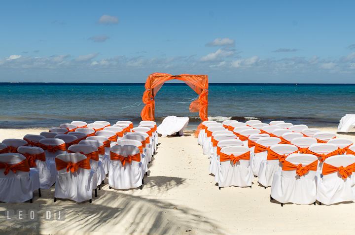 Ceremony location setting on the white sand beach, with clear blue water, and blue sky. Cruise ship destination wedding ceremony photos, Hotel Melia Cozumel Mexico by photographers of Leo Dj Photography.