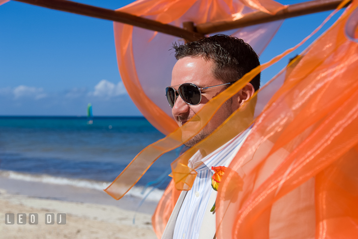 Groom smiling watching Bride walking down the isle. Cruise ship destination wedding ceremony photos, Hotel Melia Cozumel Mexico by photographers of Leo Dj Photography.