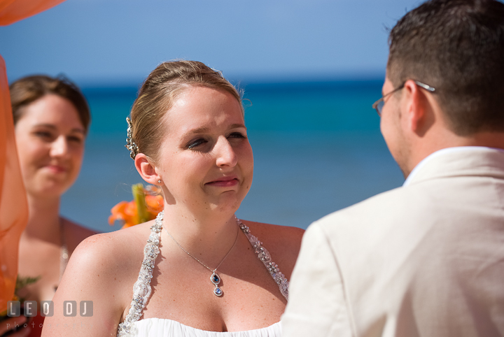 Bride gets emotional during vow recitation. Cruise ship destination wedding ceremony photos, Hotel Melia Cozumel Mexico by photographers of Leo Dj Photography.