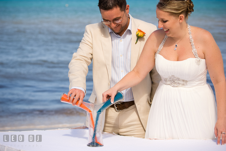 Bride and Groom pouring unity sand. Cruise ship destination wedding ceremony photos, Hotel Melia Cozumel Mexico by photographers of Leo Dj Photography.