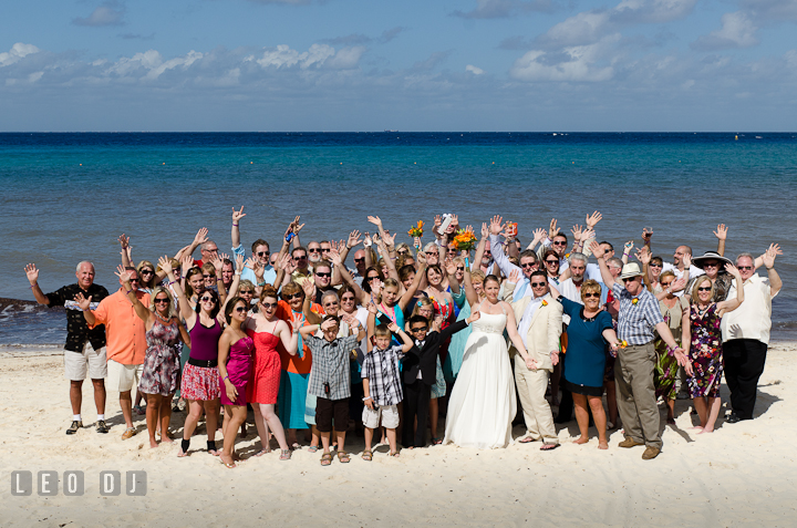 Group shot on the beach. Carnival Cruise ship destination wedding reception photos of Jessica and Chad, Cozumel Mexico by photographers of Leo Dj Photography.