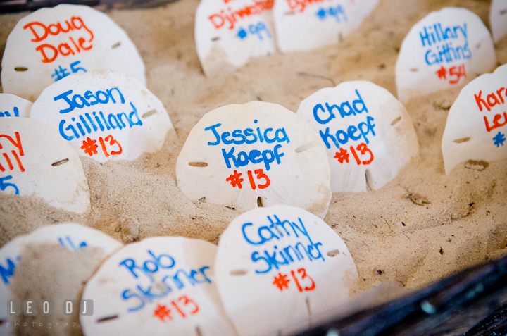 Sand dollars for table assignment cards. Carnival Cruise ship destination wedding reception photos of Jessica and Chad, Cozumel Mexico by photographers of Leo Dj Photography.