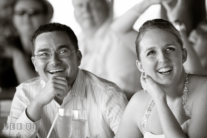 Bride and Groom laughing during speech. Carnival Cruise ship destination wedding reception photos of Jessica and Chad, Cozumel Mexico by photographers of Leo Dj Photography.