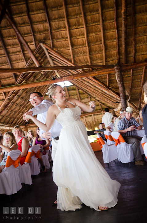 Groom twirling Bride during first dance. Carnival Cruise ship destination wedding reception photos of Jessica and Chad, Cozumel Mexico by photographers of Leo Dj Photography.