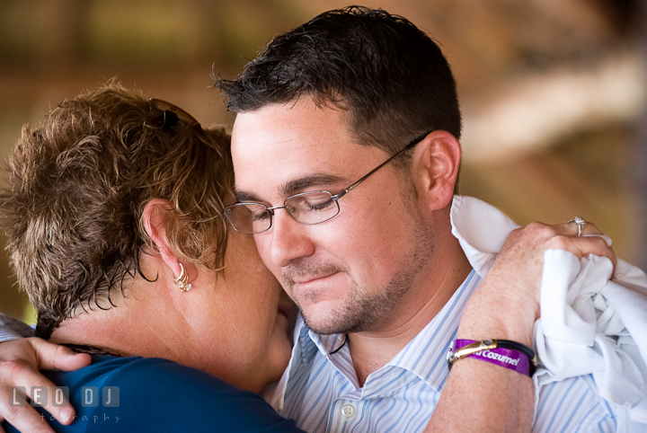 Mom hugged Groom during Mother and Son dance. Carnival Cruise ship destination wedding reception photos of Jessica and Chad, Cozumel Mexico by photographers of Leo Dj Photography.