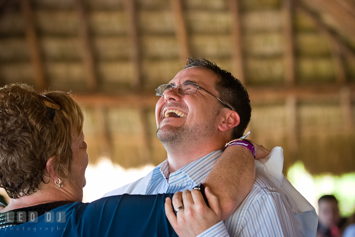 Groom laughed during Mother Son dance. Carnival Cruise ship destination wedding reception photos of Jessica and Chad, Cozumel Mexico by photographers of Leo Dj Photography.