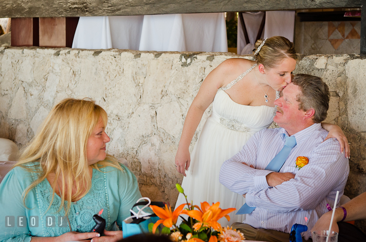 Bride kissed Dad sitting by the table. Carnival Cruise ship destination wedding reception photos of Jessica and Chad, Cozumel Mexico by photographers of Leo Dj Photography.