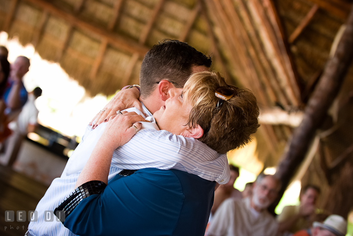 Groom hugged Mom during Mother Son dance. Carnival Cruise ship destination wedding reception photos of Jessica and Chad, Cozumel Mexico by photographers of Leo Dj Photography.