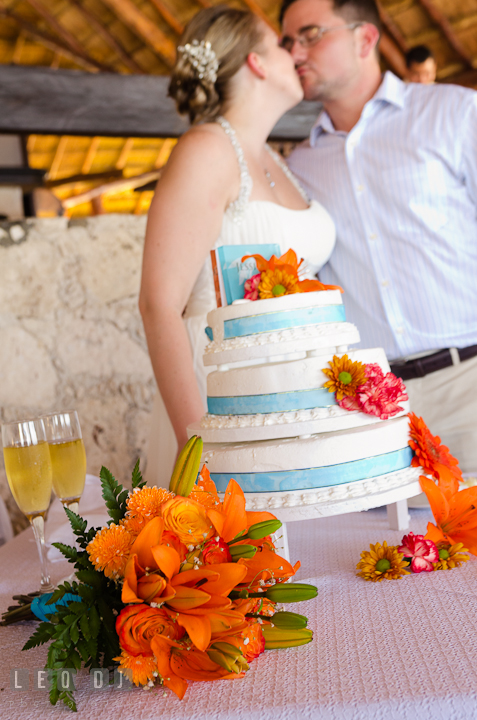 Bride and Groom kissed after cutting the cake. Carnival Cruise ship destination wedding reception photos of Jessica and Chad, Cozumel Mexico by photographers of Leo Dj Photography.