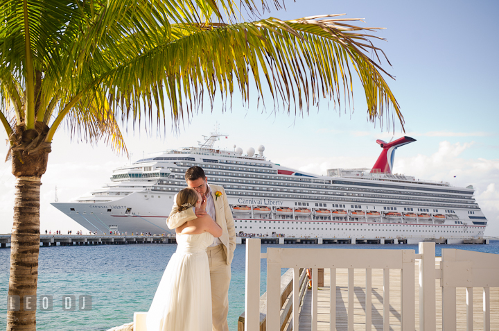 Bride and Groom kissing by where the cruise ship docked. Carnival Cruise ship destination wedding reception photos of Jessica and Chad, Cozumel Mexico by photographers of Leo Dj Photography.