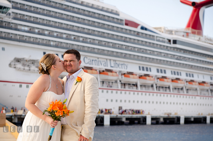 Bride kissed Groom by the ship. Carnival Cruise ship destination wedding reception photos of Jessica and Chad, Cozumel Mexico by photographers of Leo Dj Photography.