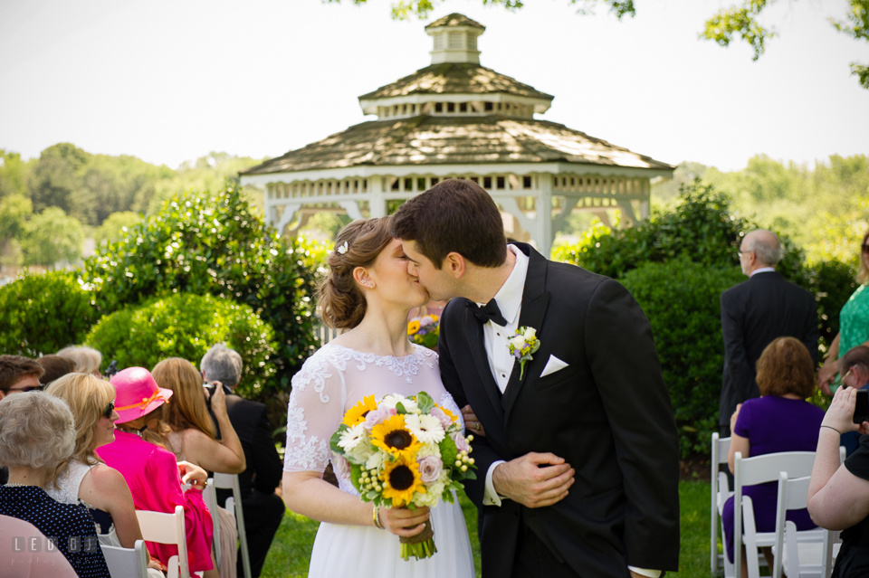 Kent Manor Inn Bride and Groom kissing during wedding ceremony processional photo by Leo Dj Photography