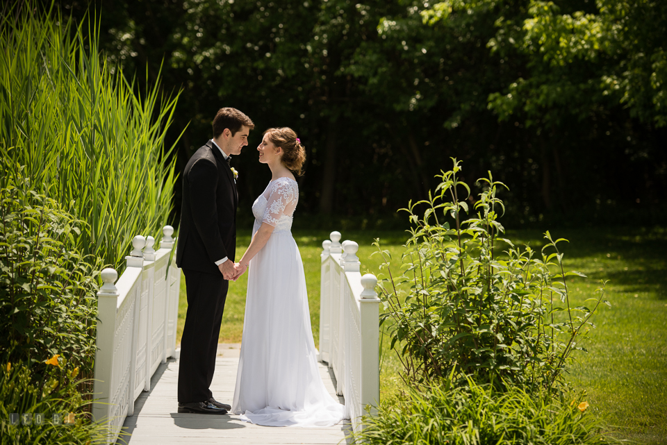 Kent Manor Inn Bride and Groom holding hands on bridge photo by Leo Dj Photography