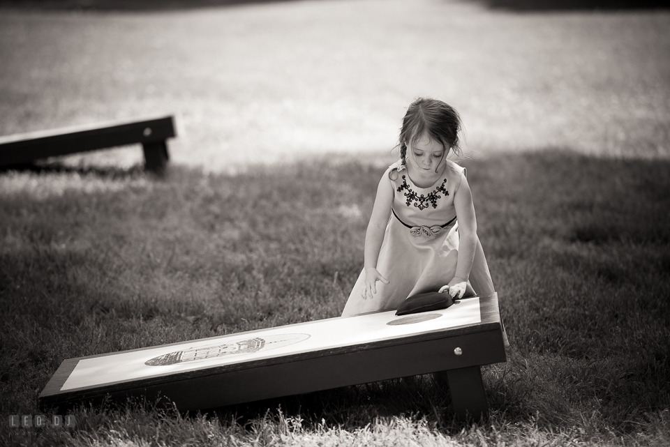 Kent Manor Inn wedding guest little girl playing corn hole photo by Leo Dj Photography