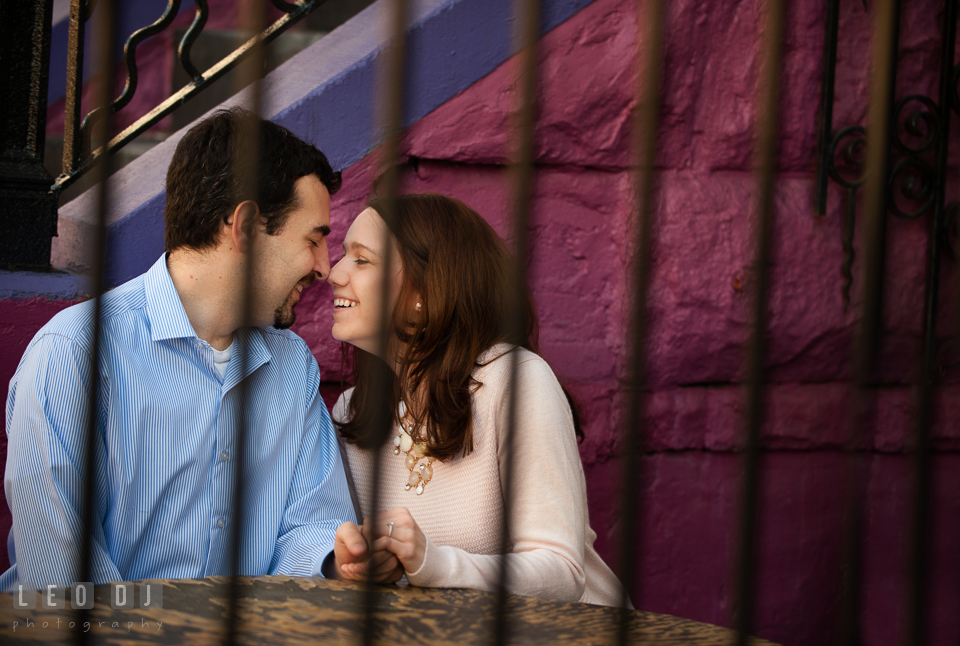 Engaged couple sitting together laughing. Washington DC pre-wedding engagement photo session at Adams Morgan and the Smithsonians, by wedding photographers of Leo Dj Photography. http://leodjphoto.com