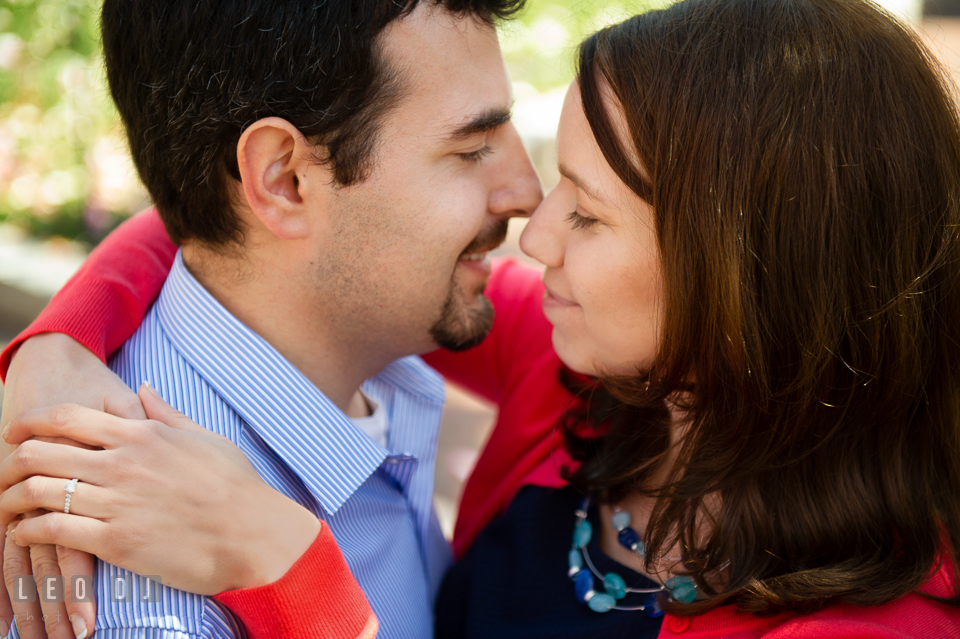 Engaged girl cuddling with her fiancé. Washington DC pre-wedding engagement photo session at Adams Morgan and the Smithsonians, by wedding photographers of Leo Dj Photography. http://leodjphoto.com