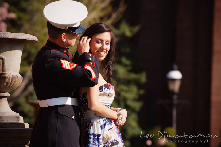 Engaged Marine officer in military uniform brushing his fiancée's hair. Pre wedding engagement photo Washington DC Smithsonians museum and Ronald Reagan Washington National Airport DCA, by wedding photographer Leo Dj Photography