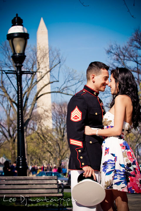 Engaged girl cuddled with her fiancé, a Marine officer in military uniform. Washington Monument in the background. Pre wedding engagement photo Washington DC Smithsonians museum and Ronald Reagan Washington National Airport DCA, by wedding photographer Leo Dj Photography