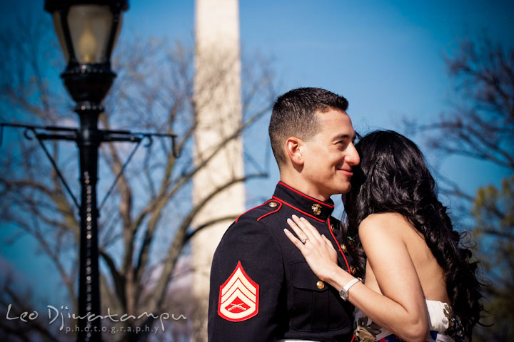 Engaged girl hugging her fiancé, a Marine officer in military uniform. Washington Monument in the background. Pre wedding engagement photo Washington DC Smithsonians museum and Ronald Reagan Washington National Airport DCA, by wedding photographer Leo Dj Photography