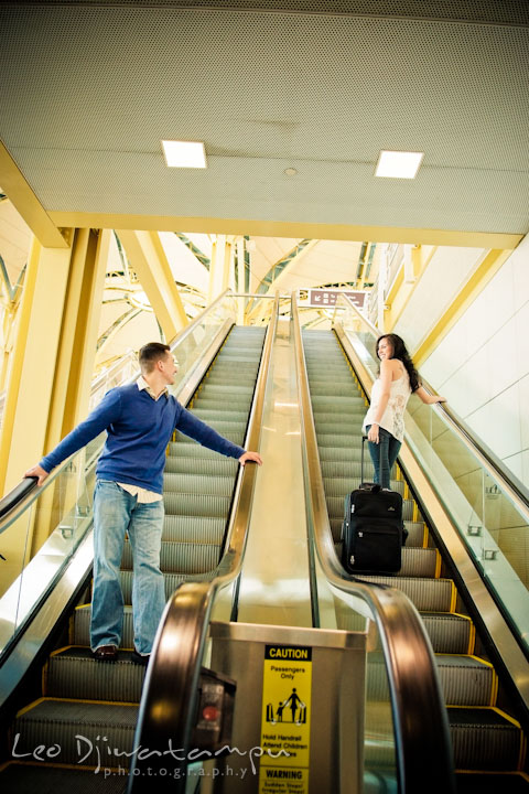 Engaged guy and girl looking at each other as they passed at the escalator. Pre wedding engagement photo Washington DC Smithsonians museum and Ronald Reagan Washington National Airport DCA, by wedding photographer Leo Dj Photography