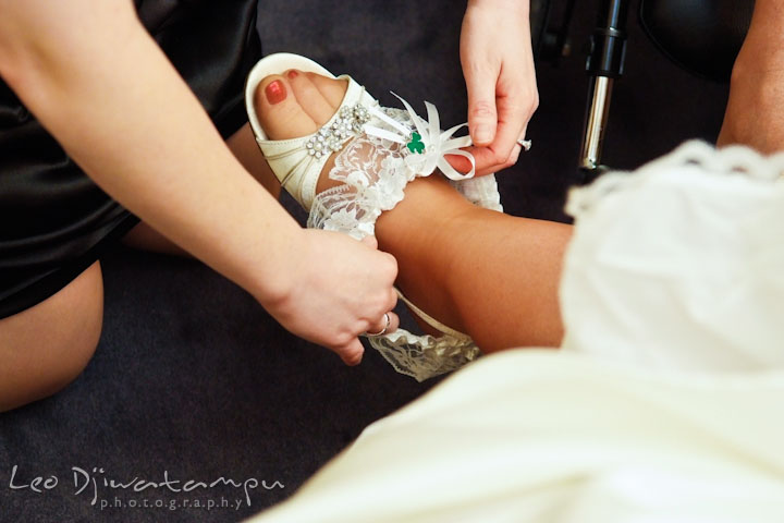 Maid of honor put garter on bride's leg. Prospect Bay Country Club Grasonville MD Wedding Photographer by Leo Dj Photography