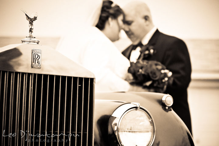 Wed bride and groom couple behind Rolls Royce limo. Prospect Bay Country Club Grasonville MD Wedding Photographer by Leo Dj Photography