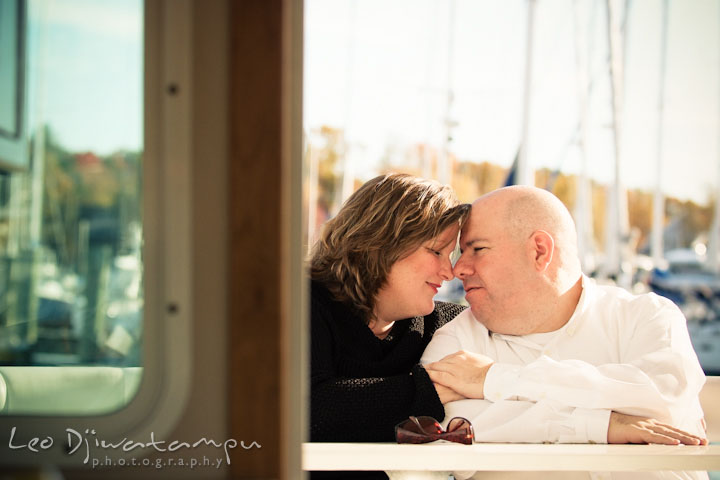 Engaged couple cuddling on a boat. Annapolis Downtown USNA Pre-wedding Engagement Photographer, Leo Dj Photography