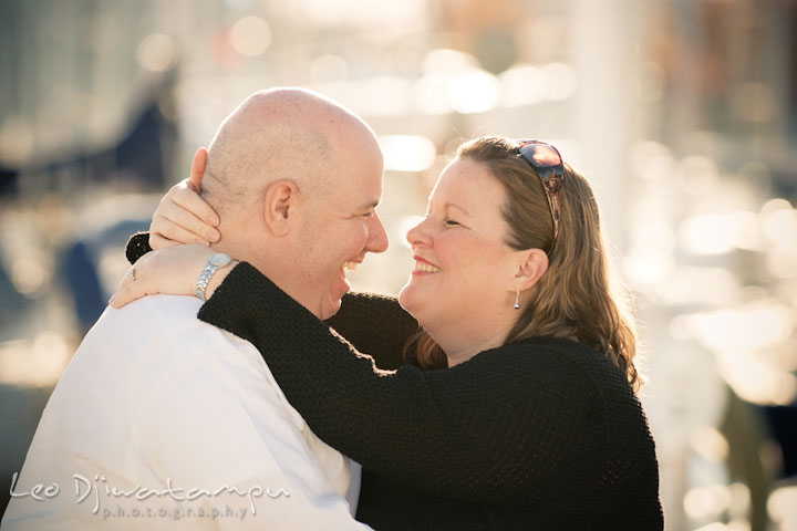 Engaged man and woman holding close and laughing together. Annapolis Downtown USNA Pre-wedding Engagement Photographer, Leo Dj Photography