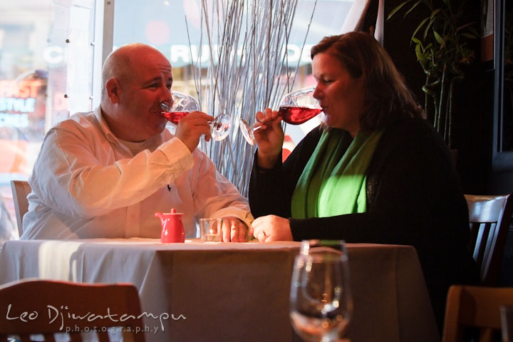 Engaged couple drinking red wine in a restaurant. Annapolis Downtown USNA Pre-wedding Engagement Photographer, Leo Dj Photography