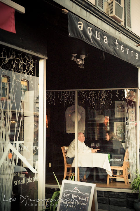 Engaged couple sitting inside Aqua Terra restaurant. Annapolis Downtown USNA Pre-wedding Engagement Photographer, Leo Dj Photography