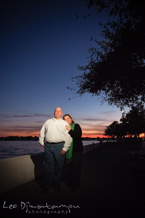 Engaged couple posing with sunset sky in the background. Annapolis Downtown USNA Pre-wedding Engagement Photographer, Leo Dj Photography