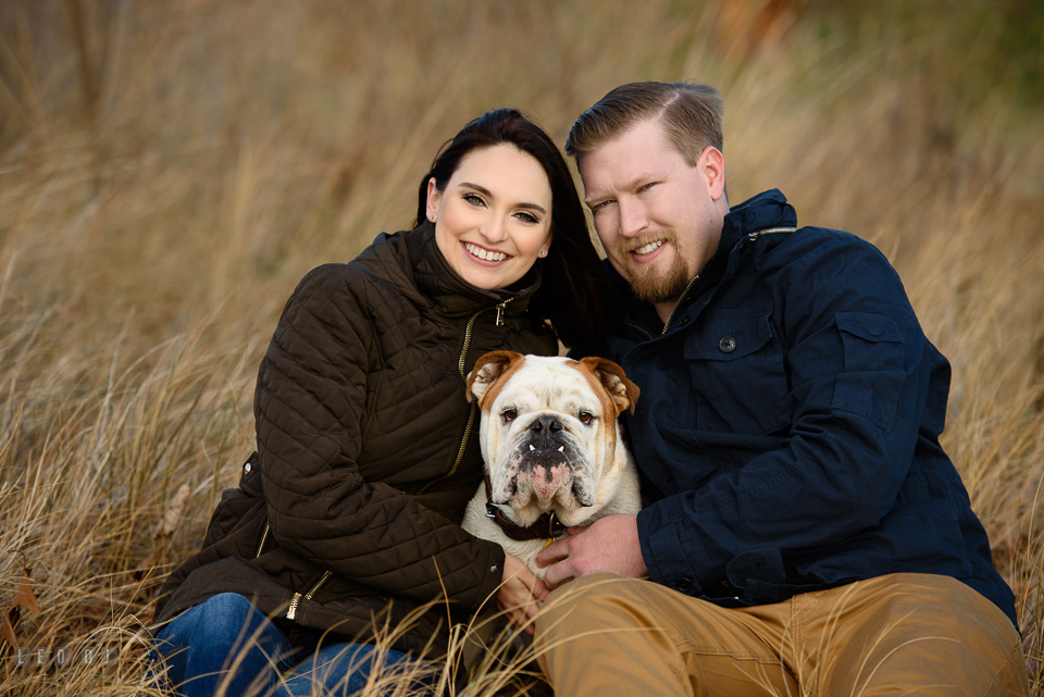 Jonas Green Park Annapolis Maryland engaged man posing with fiance and their dog photo by Leo Dj Photography.